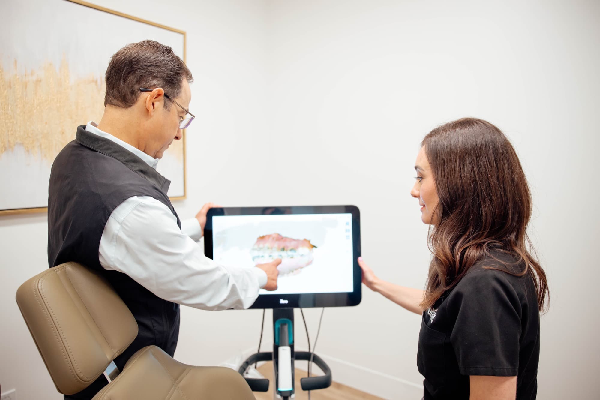 Dr. Kunik reviewing a digital scan on tablet