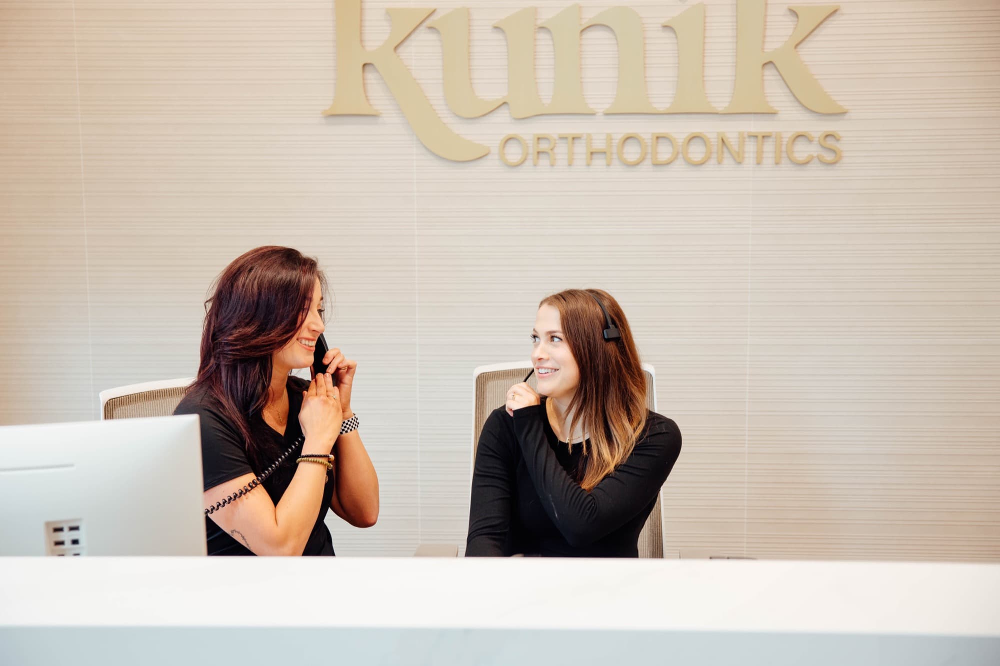 Kunik Orthodontics reception desk with team