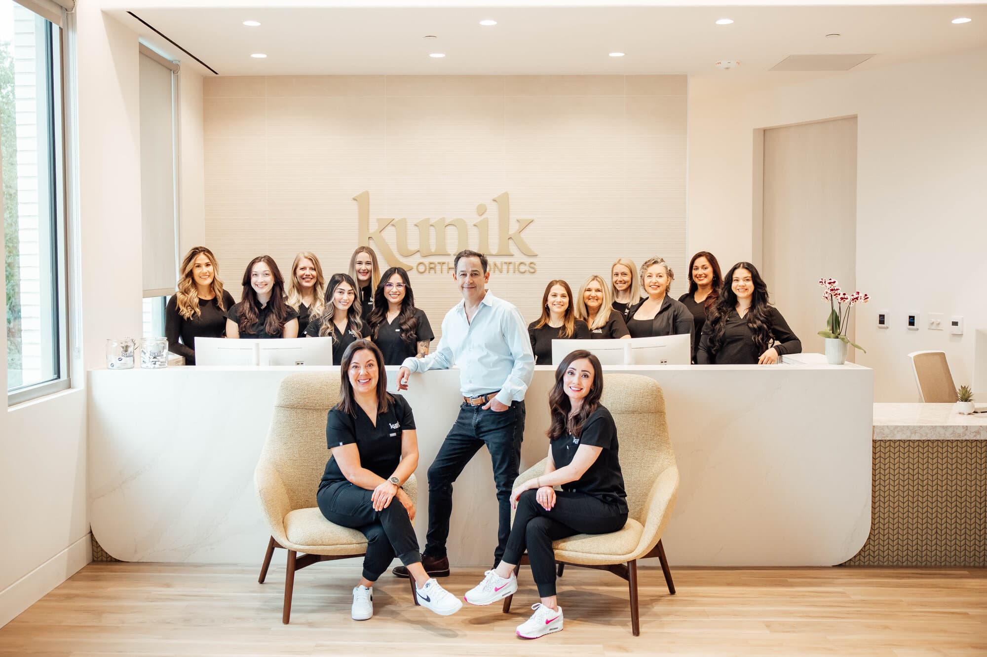 Kunik Orthodontics full team with Dr. Kunik in the office lobby