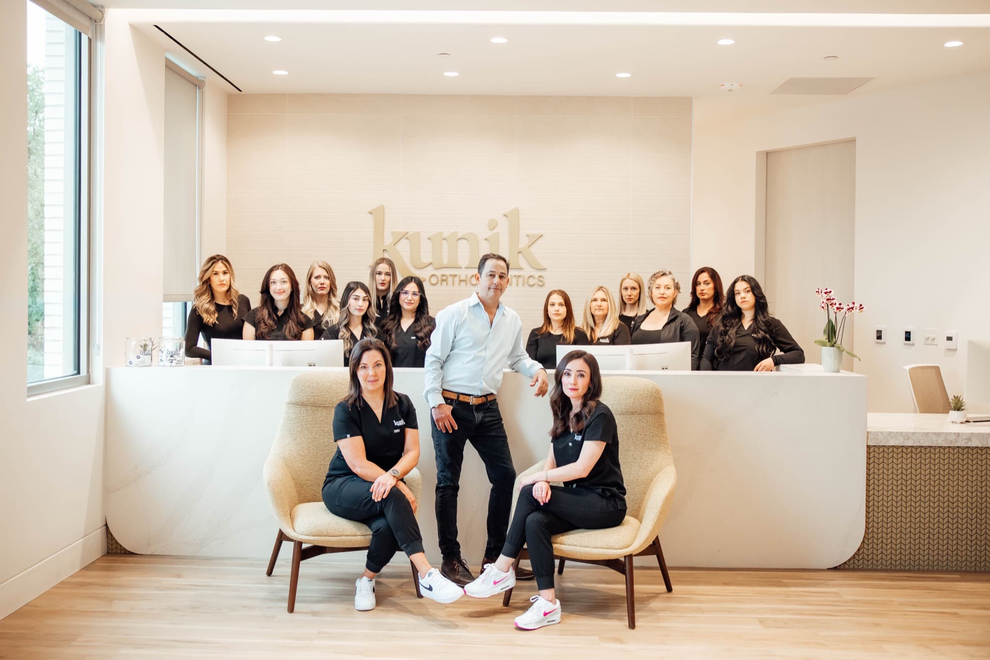 Kunik Orthodontics full team with Dr. Kunik in the office lobby