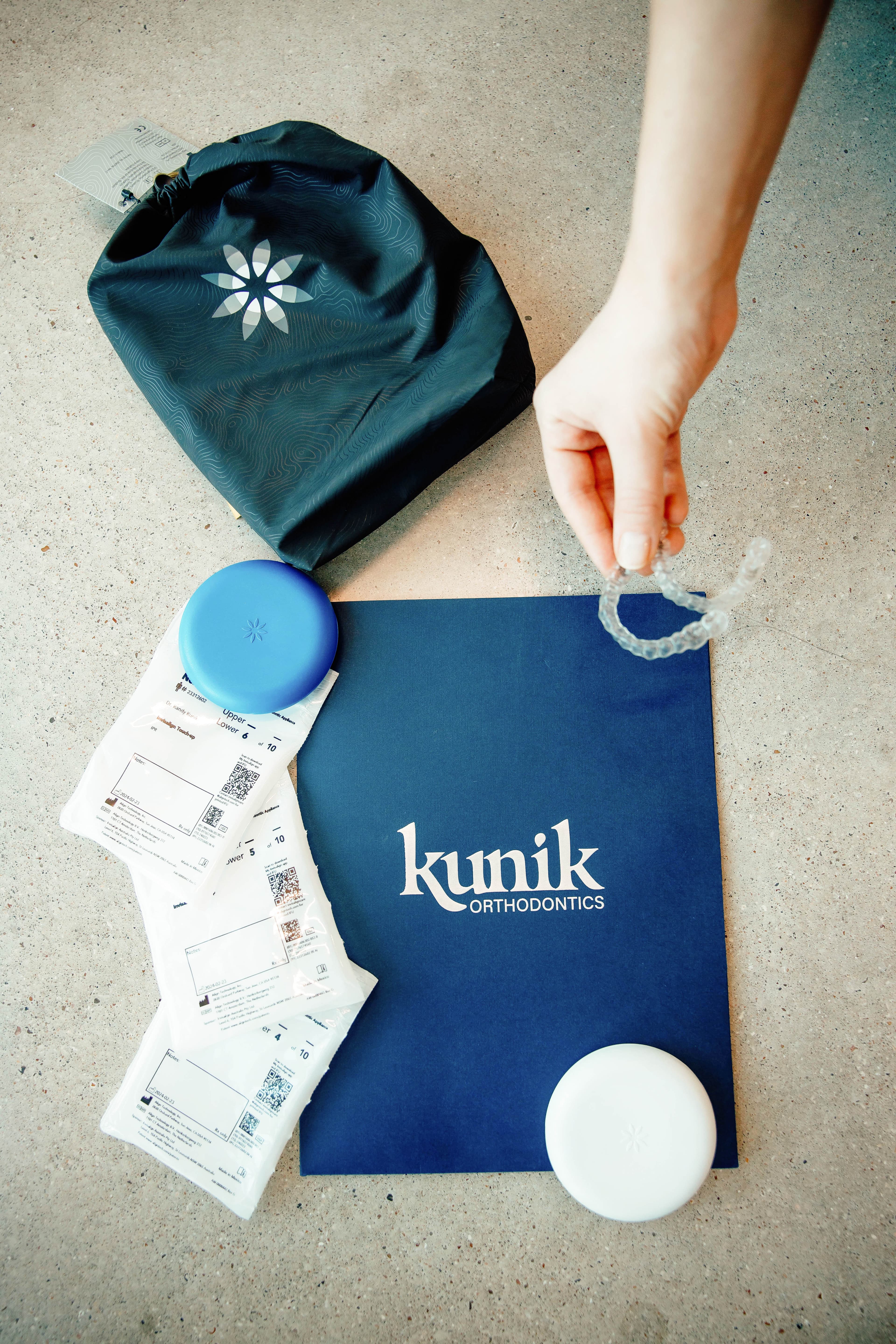 Smiling woman with Invisalign aligner