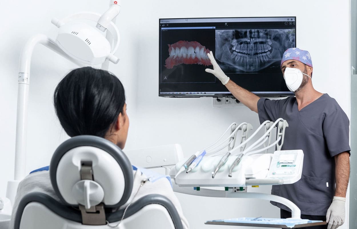 How Many Wisdom Teeth Do You Have? A dental professional showing x-rays to a patient.